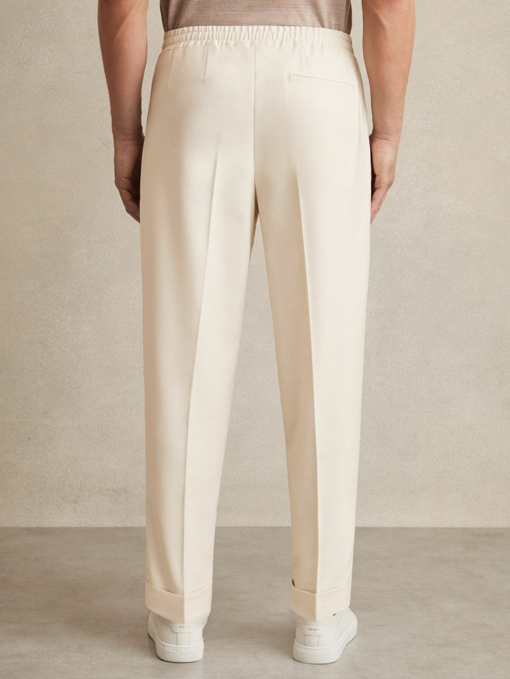 Men Relaxed-Fit Pleated Tapered Trousers in Ecru