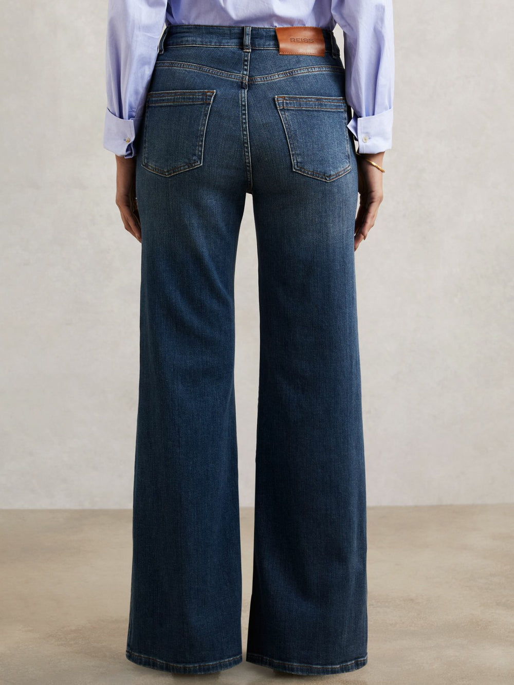 Women Petite Mid-Rise Flared Jeans in Mid Blue