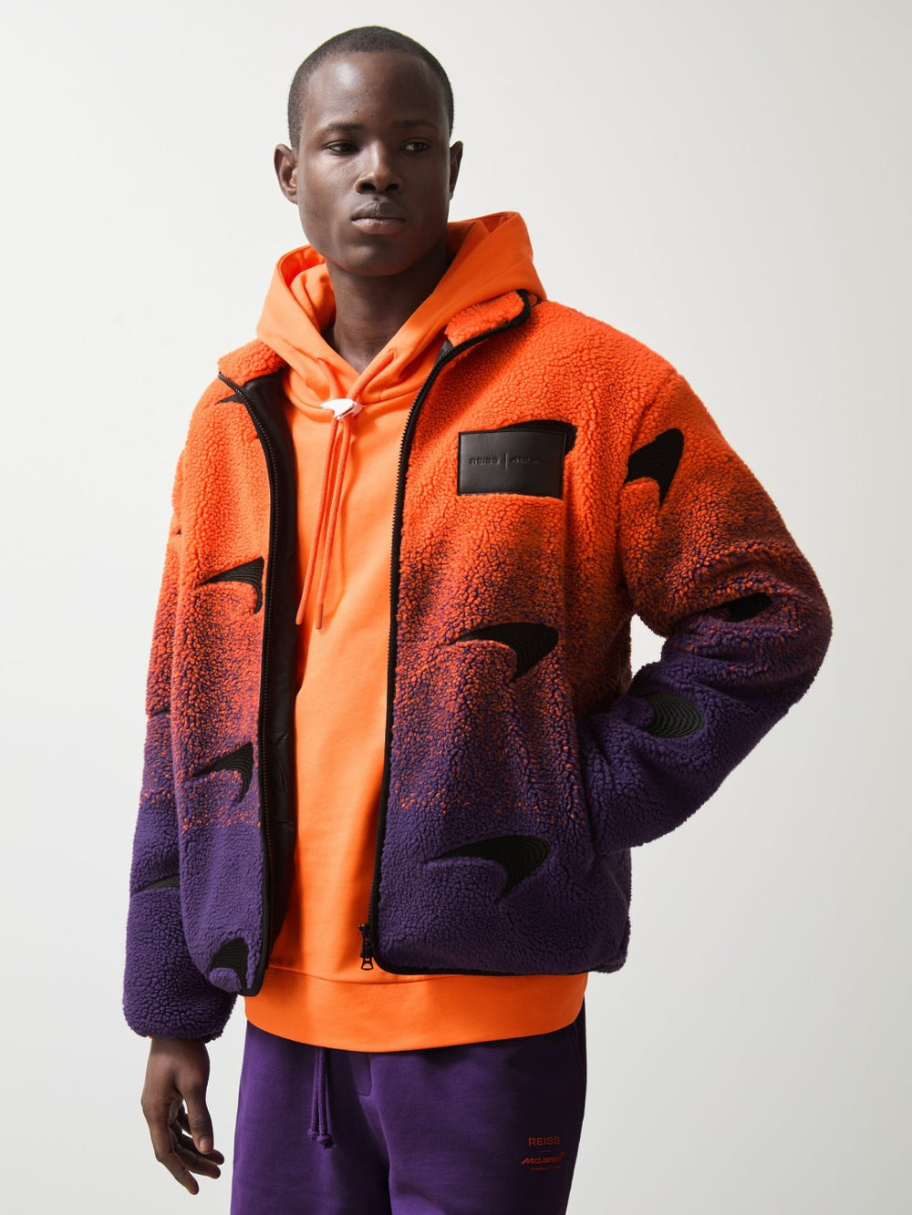 Men Unisex Fit McLaren F1 Team Ombré Fleece Jacket in Papaya Orange/Purple