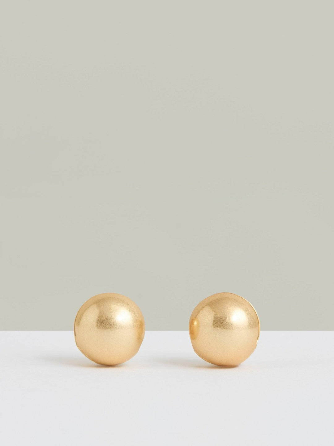 Women Polished Ball Huggie Earrings in Gold