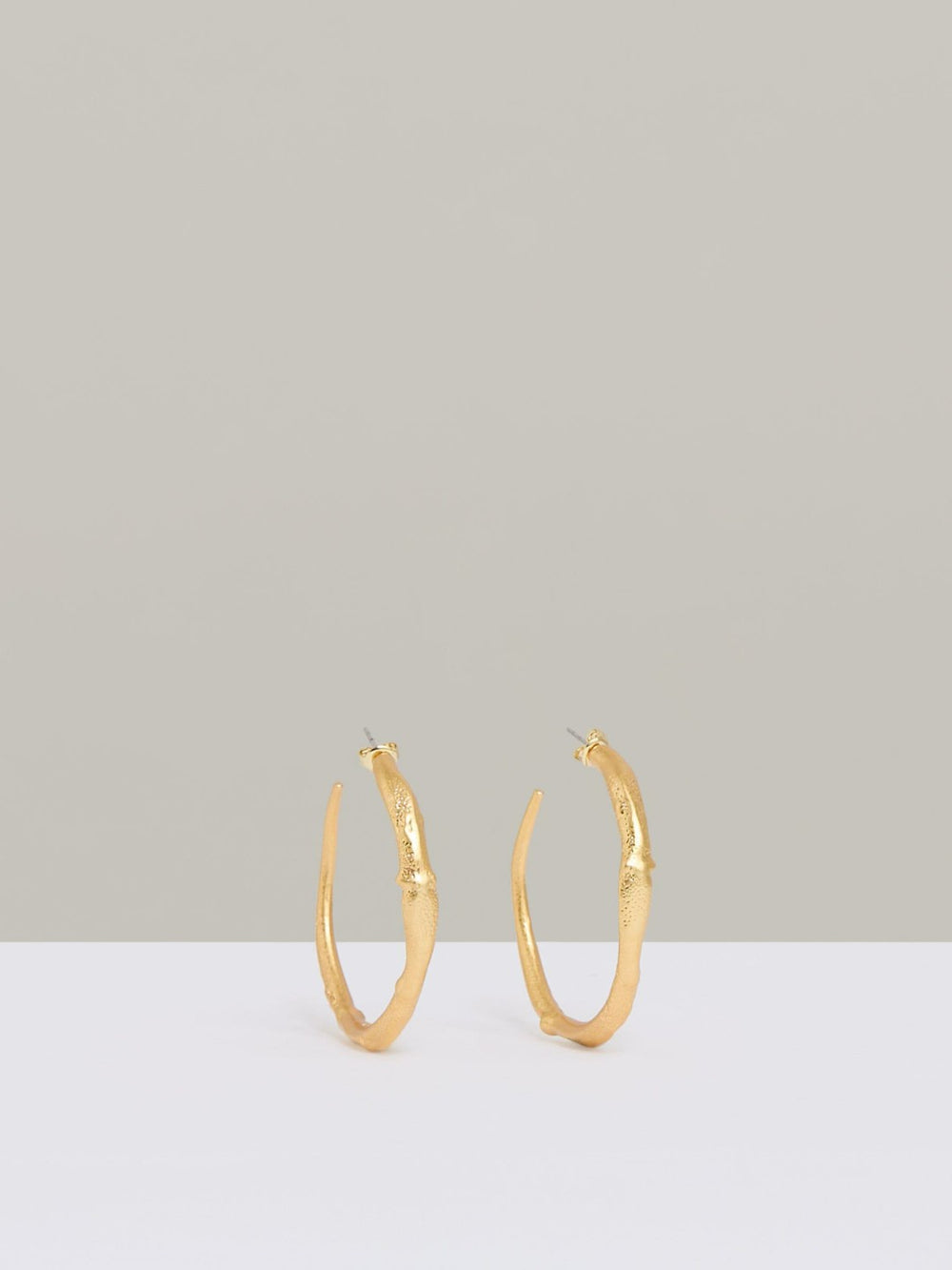 Women Molten Hoop Earrings in Gold Tone