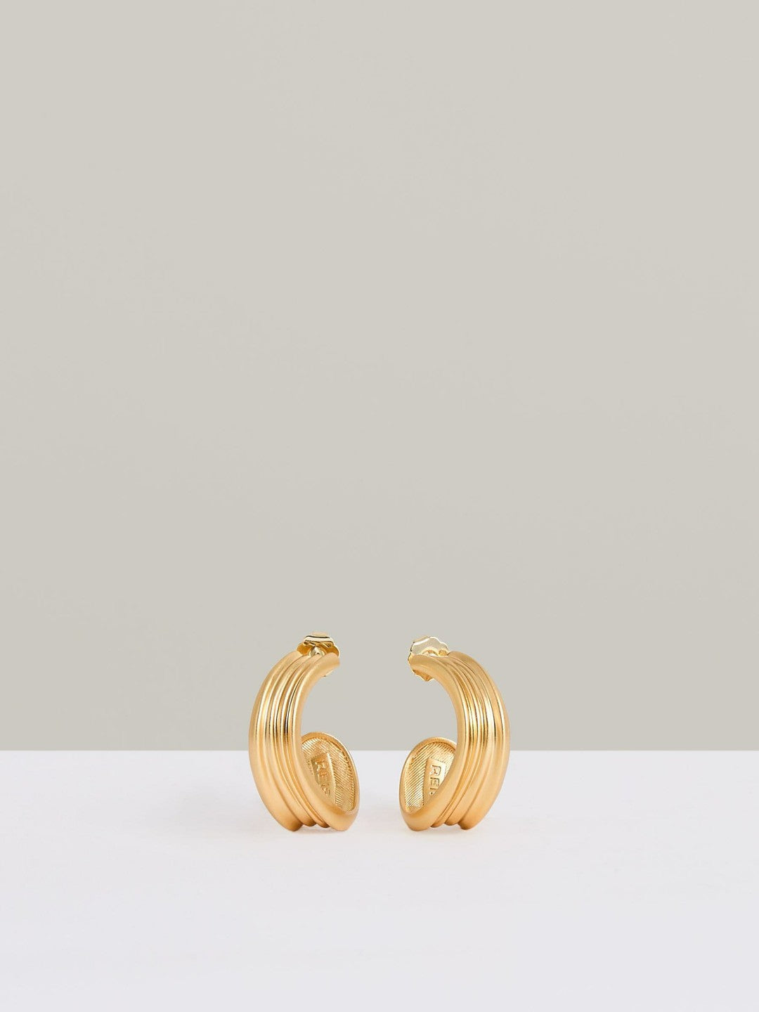 Women Fluid Hoop Earrings in Gold Tone