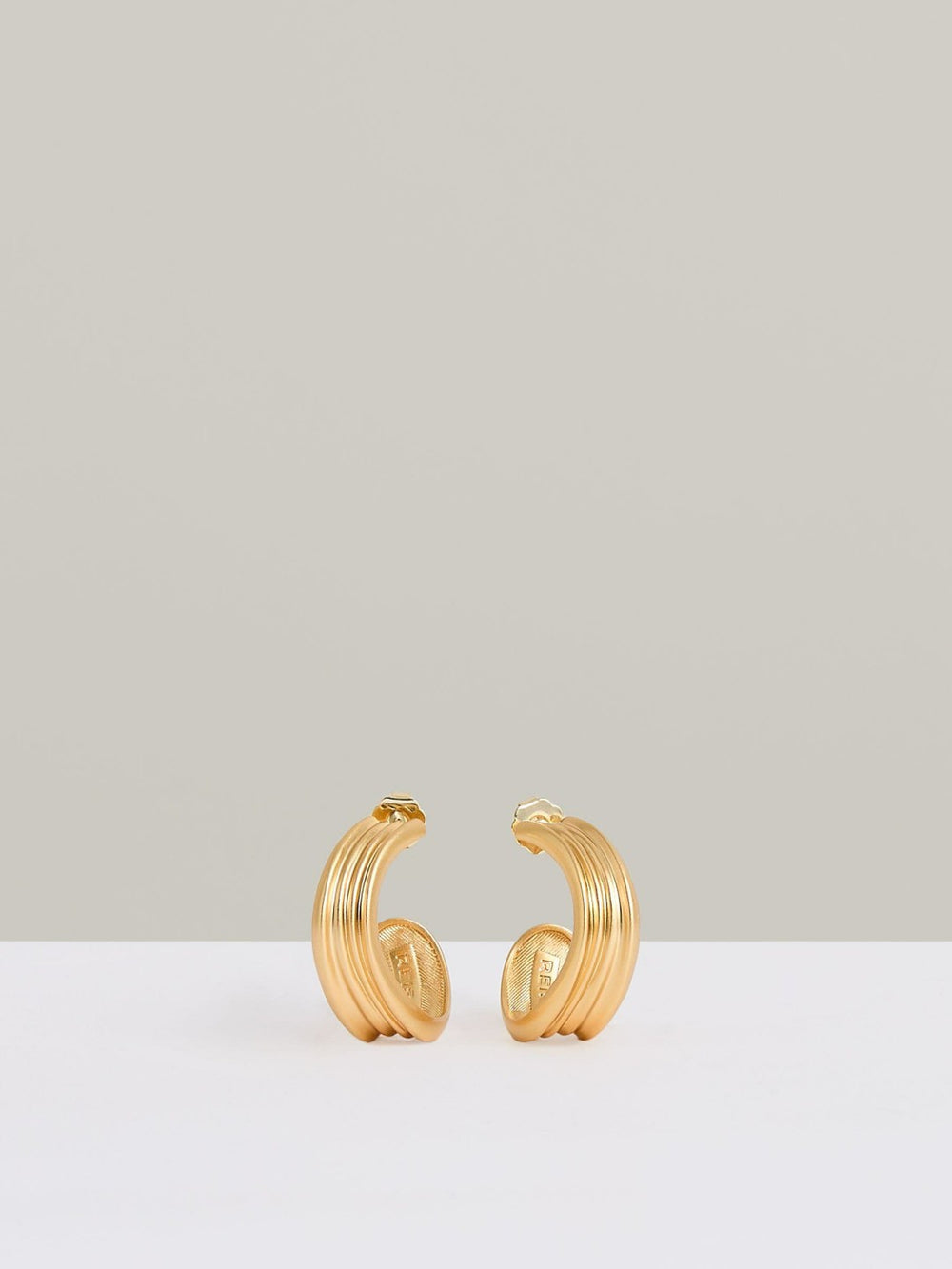 Women Fluid Hoop Earrings in Gold Tone