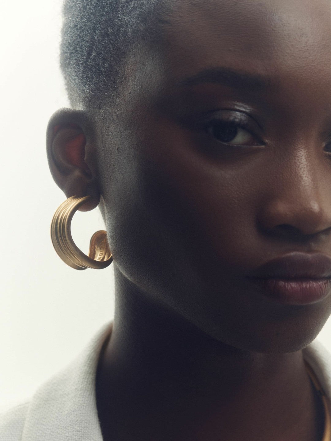 Women Fluid Hoop Earrings in Gold Tone