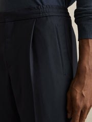 Men Relaxed-Fit Pleated Tapered Trousers in Navy